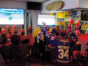 Group of people cheering watching sports
