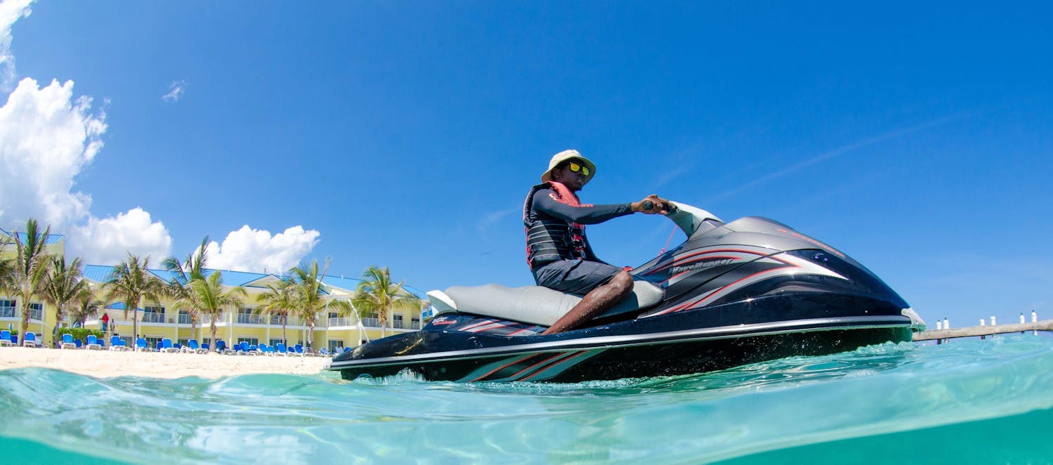 Guy with hat and sunglasses on a jetski in Cayman
