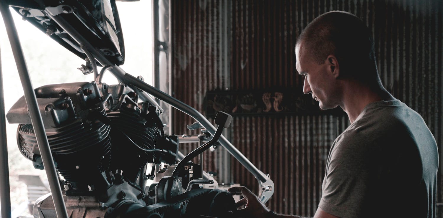 Mechanic working on a car engine in a garage