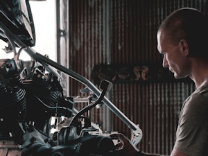 Mechanic working on a car engine in a garage