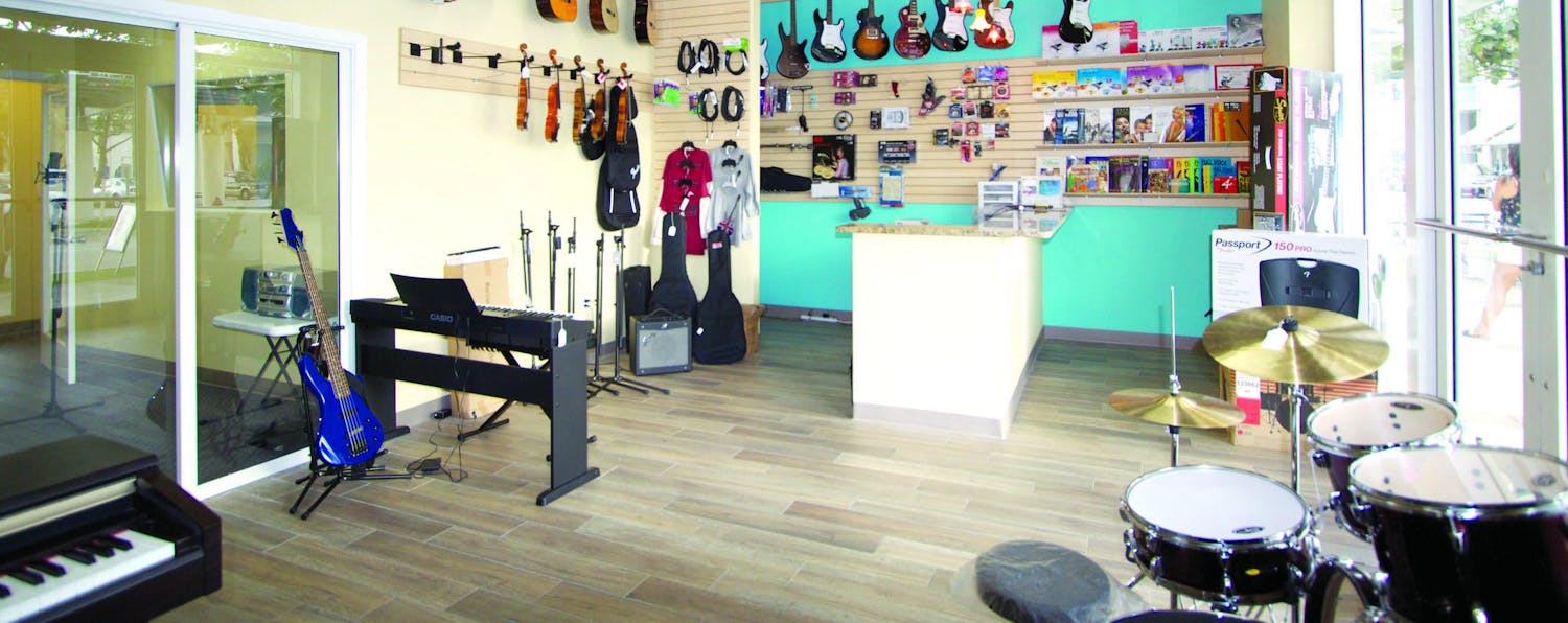 Music shop with several guitars hanging in the walls