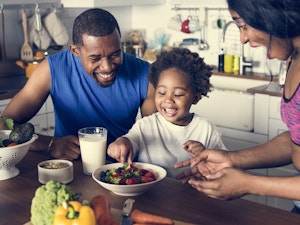 Parents Feeding Girl