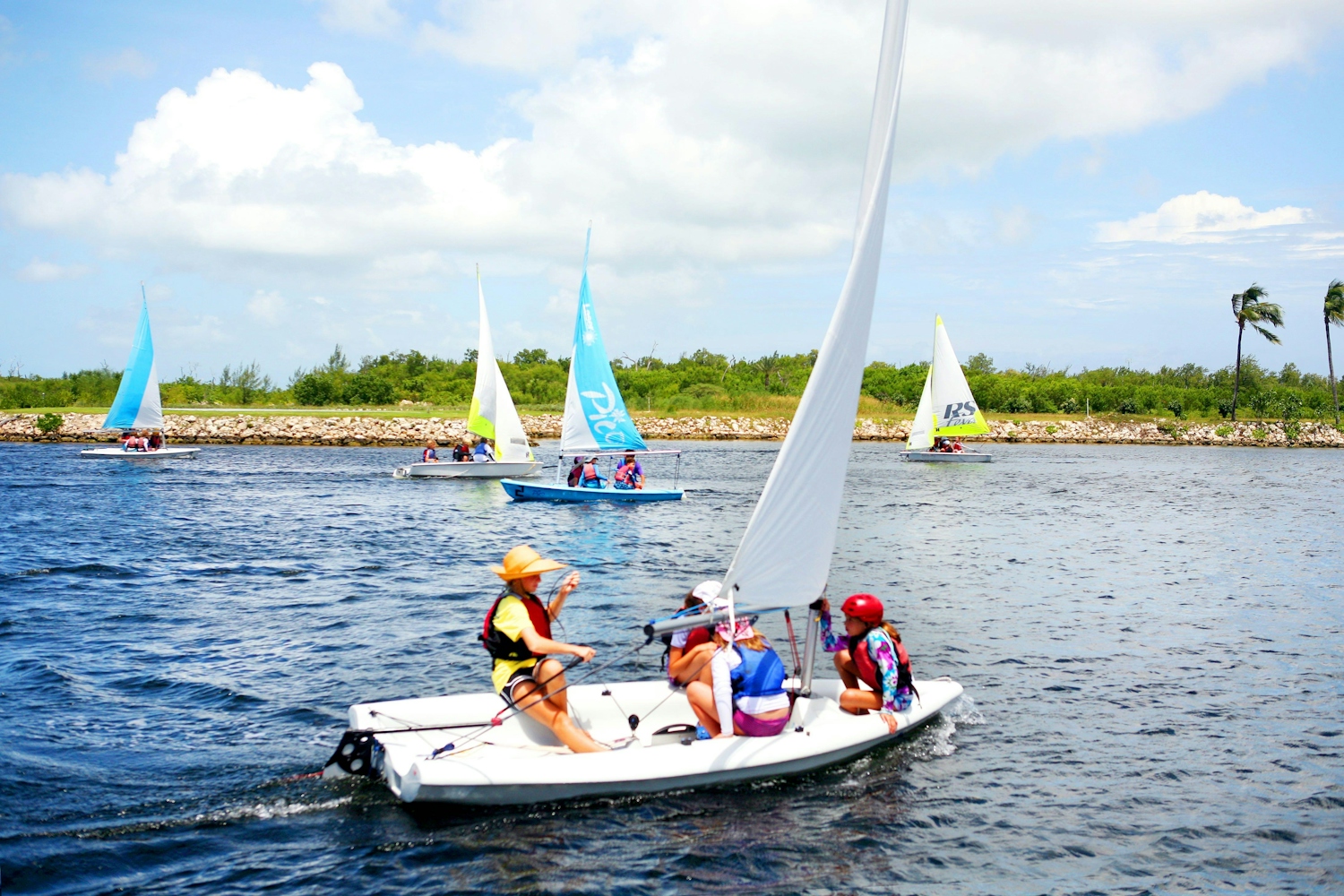 Several sailing boats in the waters of the Cayman Islands