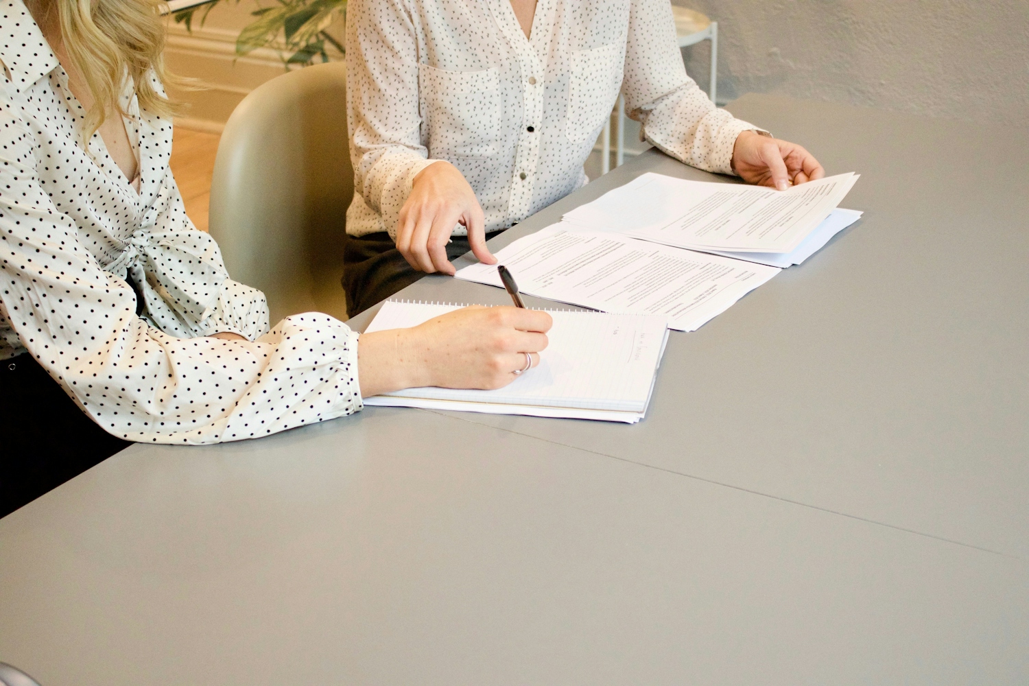 Two women reviewing papers in an interview