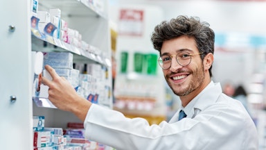 Brunette man working behind the counter at the pharmacy