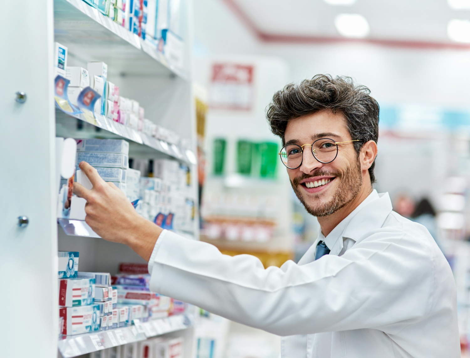 Brunette man working behind the counter at the pharmacy