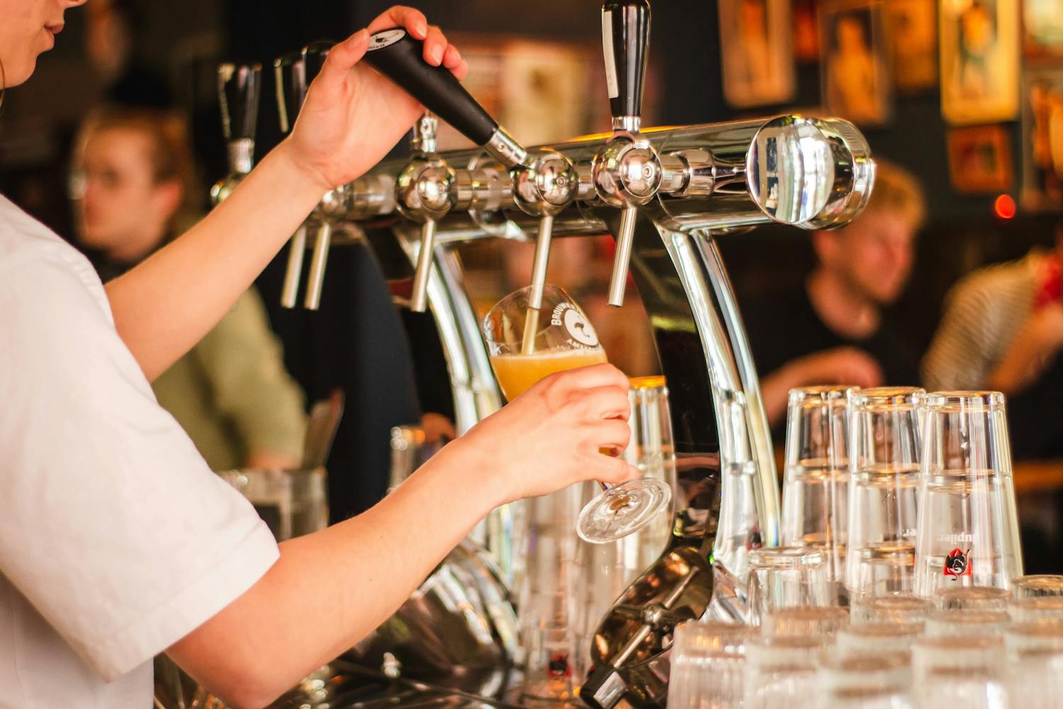 Close crop of bartender pouring a draught beer