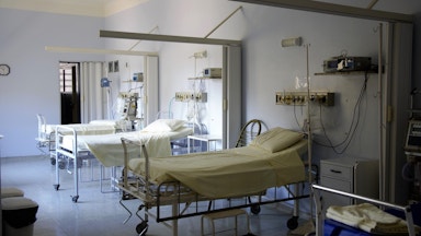 Empty hospital beds in a room