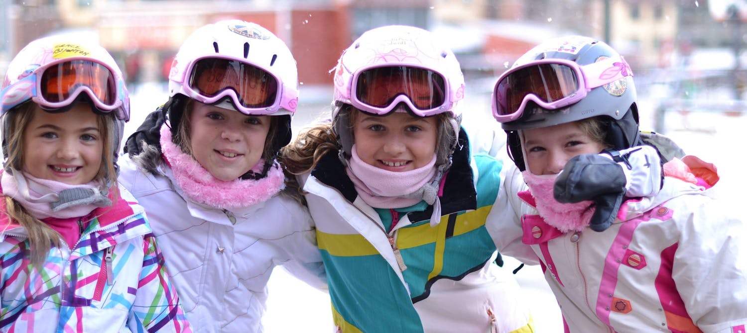 Four little girls enjoying a ski holiday
