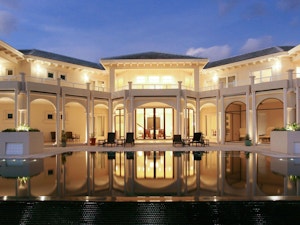 Luxury home at dusk with large infinity pool