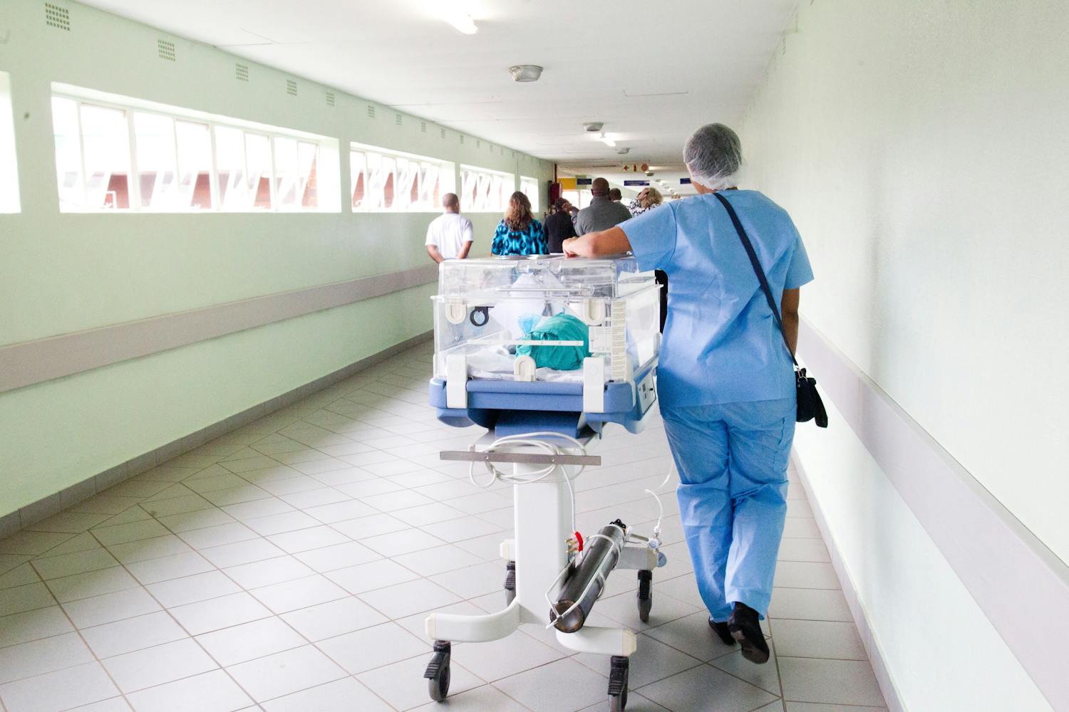 Newborn baby being walked down hospital hallway