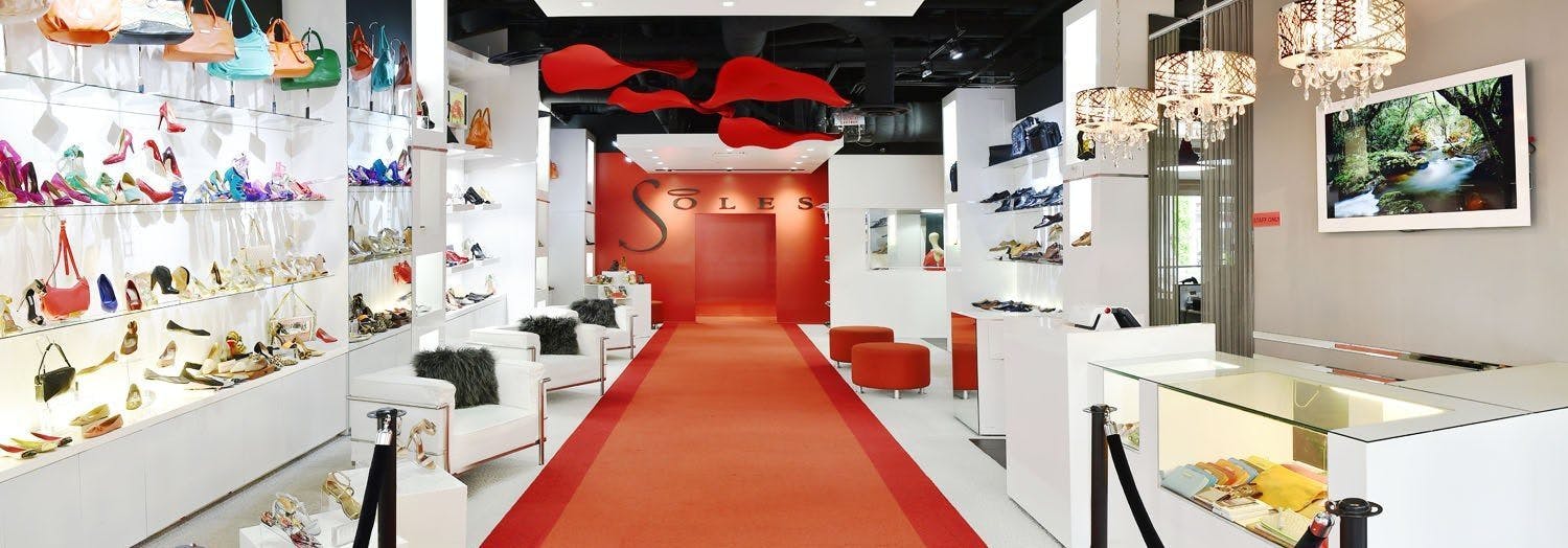 Panorama of soles shoe store with red carpet