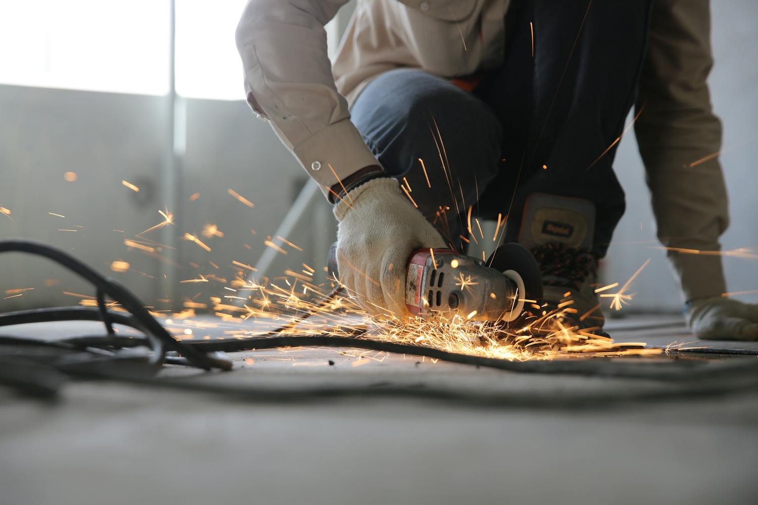 Person holding grinder with sparks