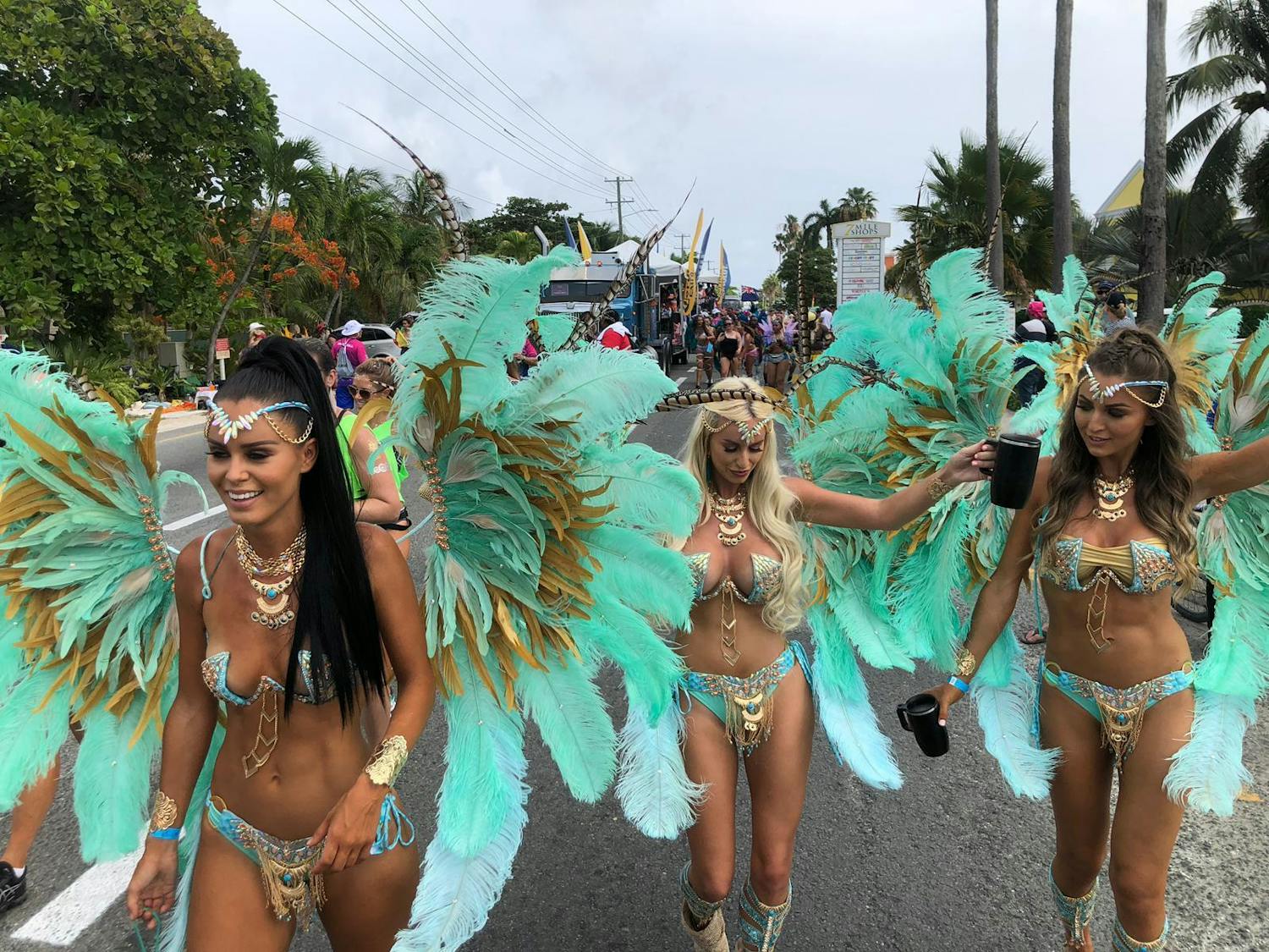Three girls in carnival wear walking down west bay road