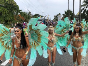 Three girls in carnival wear walking down west bay road