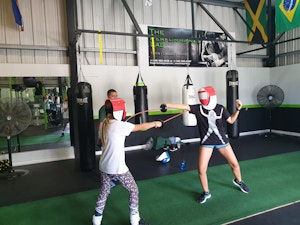 Two youth practicing fencing at the performance lab