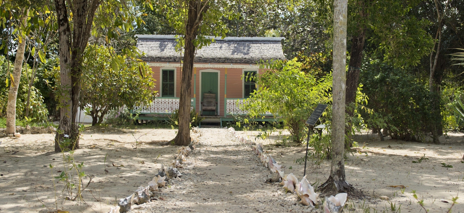 View of Cayman cottage with backing sand