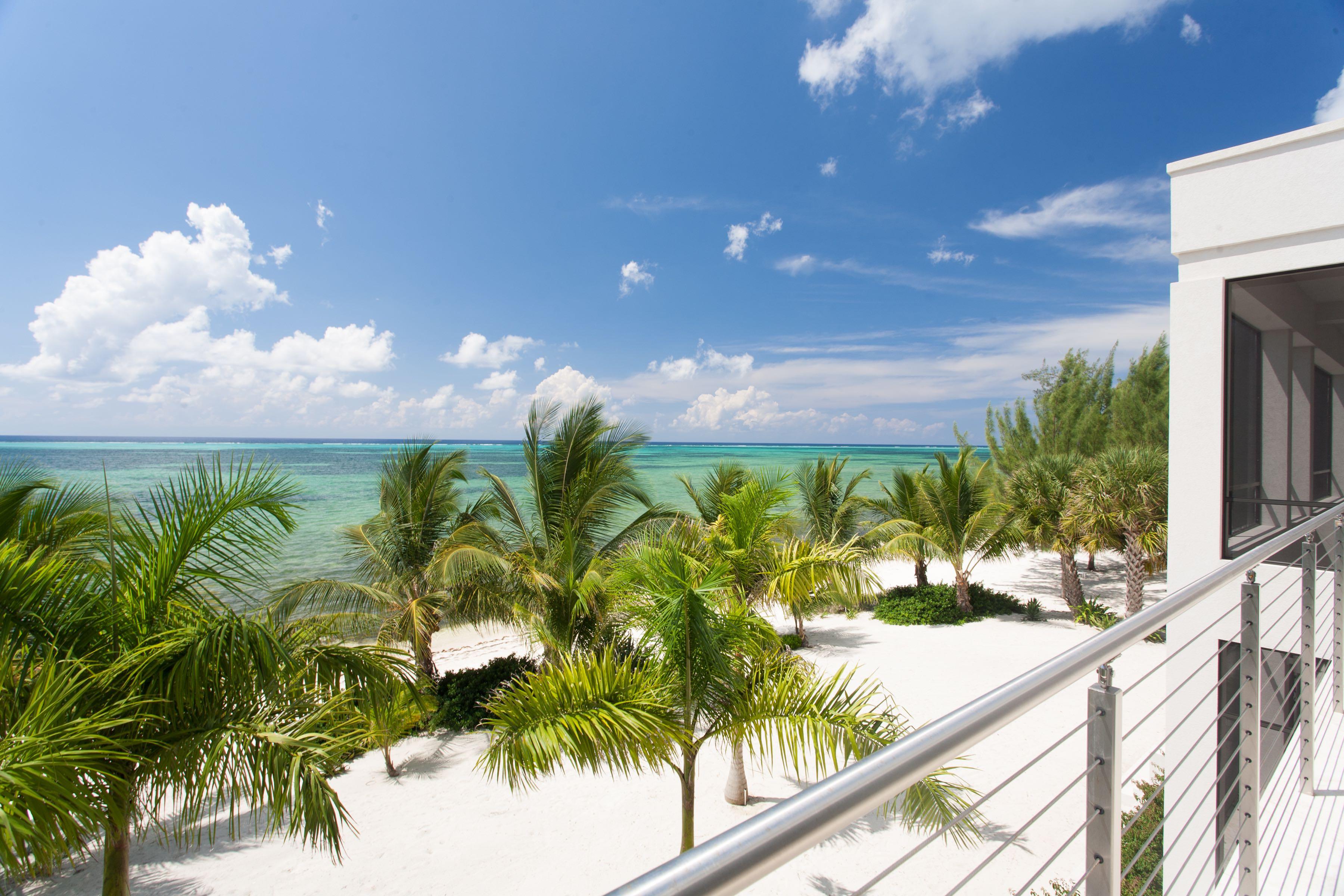 Cayman Islands Real Estate Guide Cayman Resident   View Off Of A White Luxury Condo Balcony Overlooking The Ocean 